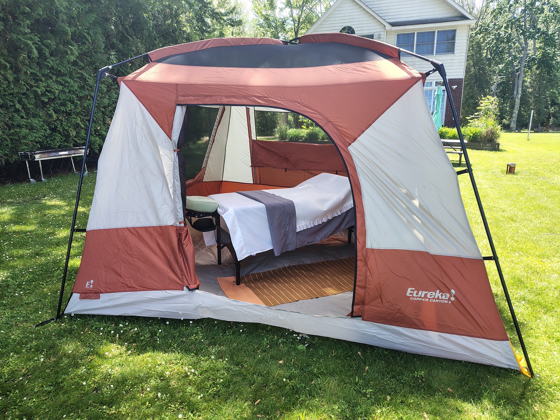 Full outdoor massage tent setup in a backyard setting